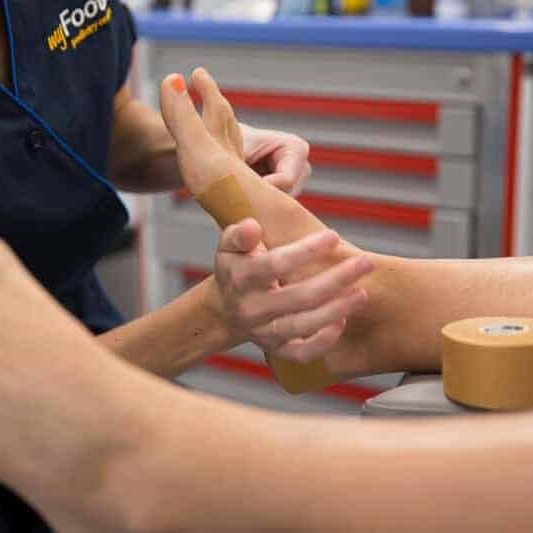 Dancing Stafford Consultations - A podiatrist managing a patient's foot