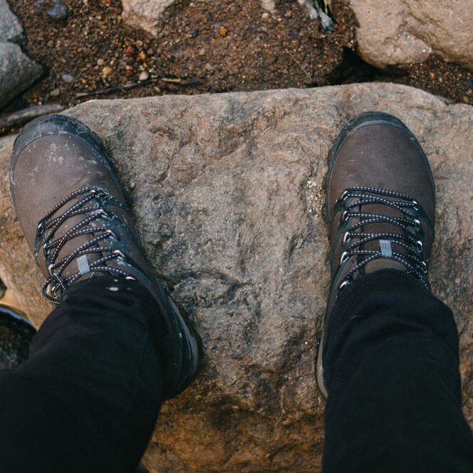 Hiking boots on a boulder